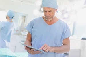 Figure 1: The old model generated 'a man in a blue shirt,' the new model generated 'a man in surgical scrubs looking at a tablet.