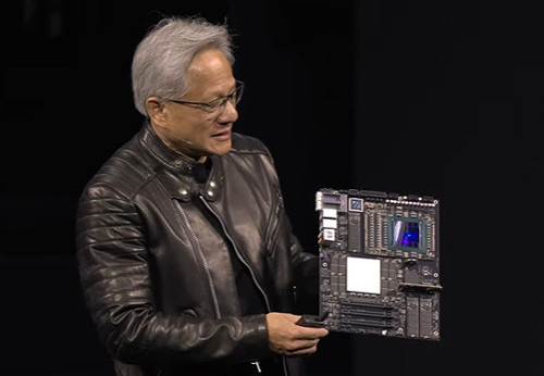 Huang holding a DGX computer